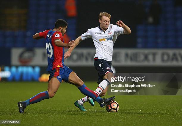 Bolton Wanderers' Chris Taylor is tackled by Crystal Palace's Ezekiel Fryers during the Emirates FA Cup Third Round match between Bolton Wanderers...