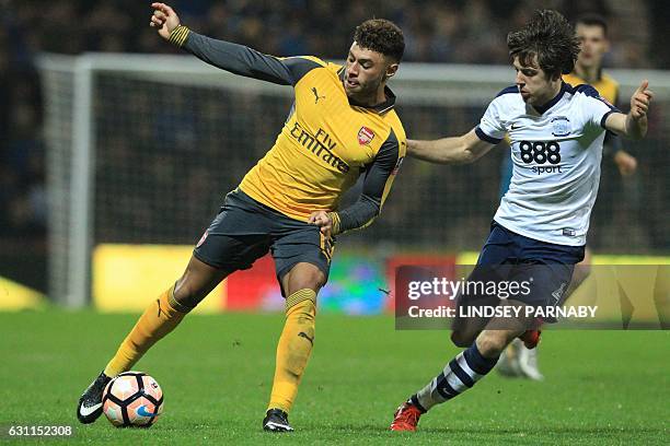 Arsenal's English midfielder Alex Oxlade-Chamberlain vies with Preston's English midfielder Ben Pearson during the English FA Cup third round...