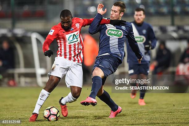 Nancy's French forward Anthony Koura vies for the ball with FC Besancon's French defender Nicolas Pesenti during the French Cup football match...