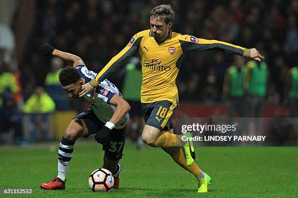 Arsenal's Spanish defender Nacho Monreal vies with Preston's English striker Callum Robinson during the English FA Cup third round football match...