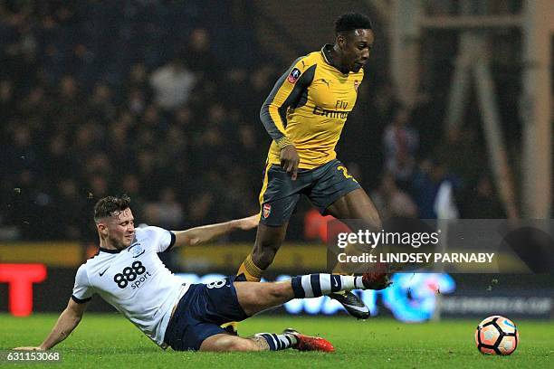 Arsenal's English striker Danny Welbeck evades a tackle from Preston's Irish midfielder Alan Browne during the English FA Cup third round football...