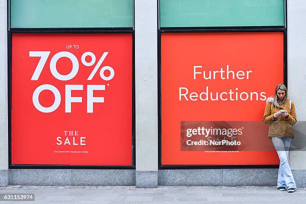 View of Brown Thomas shop window in Dublin's Grafton Street with 'Up To 70% OFF' sign as the start of the new year brings with it all January sales...