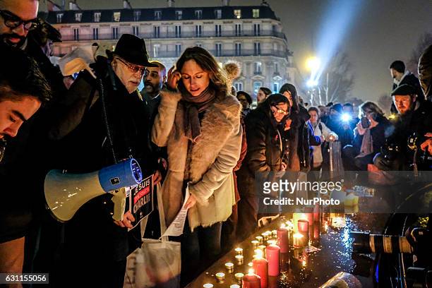 Members of the public light candles during a rally commemorating the second anniversary of the deadly attack against the satirical weekly Charlie...