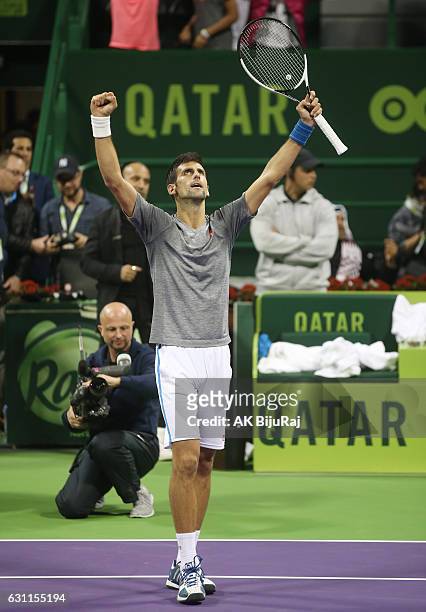 Novak Djokovic of Serbia celebrates after beating Andy Murray of Great Britain in the men's singles final match of the ATP Qatar Open tennis...