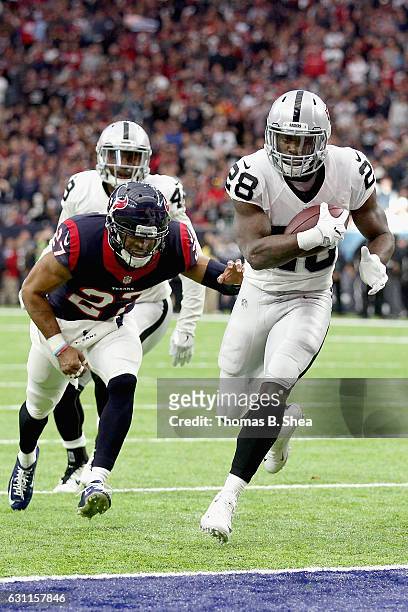 Latavius Murray of the Oakland Raiders eludes Quintin Demps of the Houston Texans for a touchdown in the AFC Wild Card game at NRG Stadium on January...