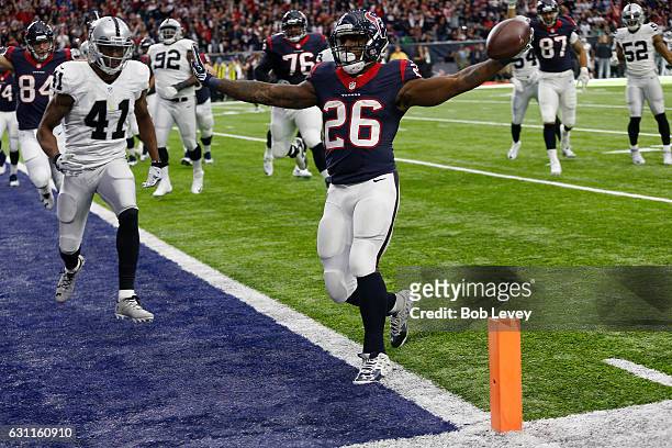 Lamar Miller of the Houston Texans rushes for a touchdown during the first quarter against the Oakland Raiders in their AFC Wild Card game at NRG...