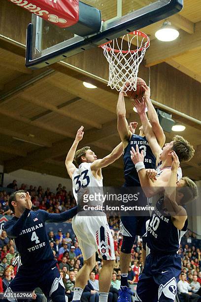 Brigham Young Cougars guard Elijah Bryant pulls down a rebound over St. Mary's Gaels forward Dane Pineau , St. Mary's Gaels forward Kyle Clark ,...