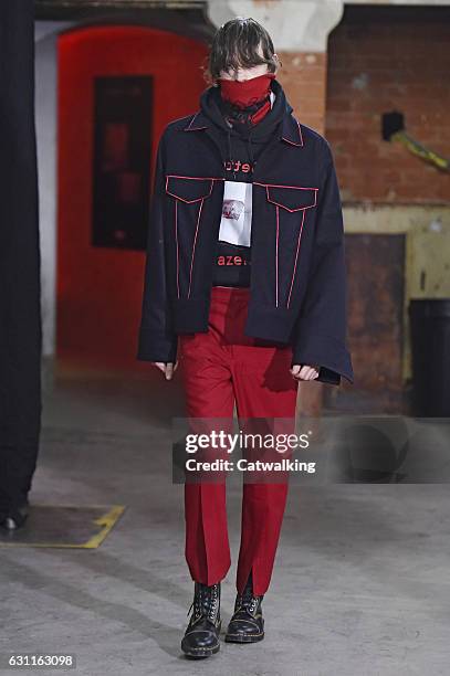 Model walks the runway at the Agi & Sam Autumn Winter 2017 fashion show during London Menswear Fashion Week on January 7, 2017 in London, United...