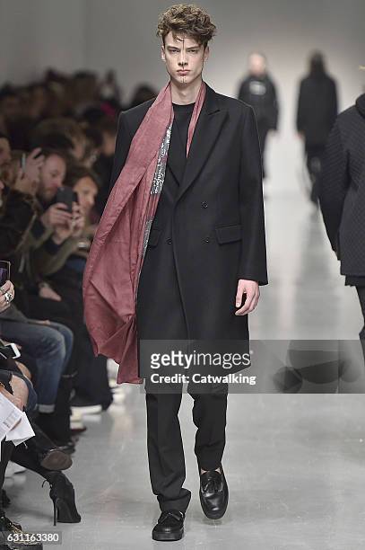 Model walks the runway at the Matthew Miller Autumn Winter 2017 fashion show during London Menswear Fashion Week on January 7, 2017 in London, United...