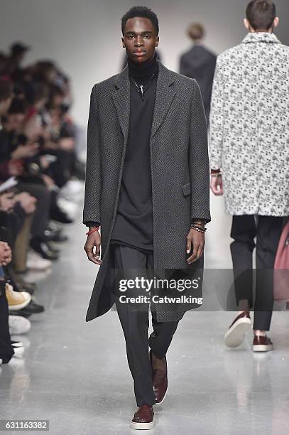 Model walks the runway at the Matthew Miller Autumn Winter 2017 fashion show during London Menswear Fashion Week on January 7, 2017 in London, United...