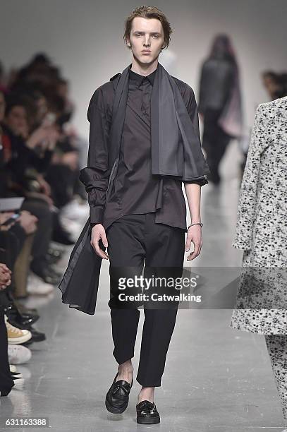 Model walks the runway at the Matthew Miller Autumn Winter 2017 fashion show during London Menswear Fashion Week on January 7, 2017 in London, United...