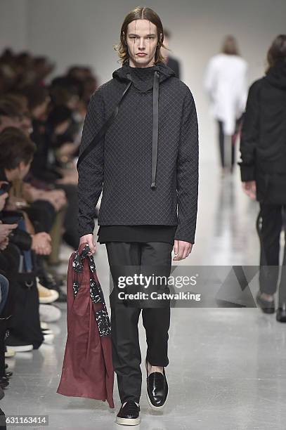 Model walks the runway at the Matthew Miller Autumn Winter 2017 fashion show during London Menswear Fashion Week on January 7, 2017 in London, United...