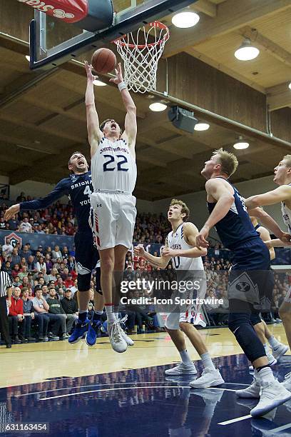 St. Mary's Gaels forward Dane Pineau grabs a rebound in front of Brigham Young Cougars guard Nick Emery during the first half of the Gaels' 81-68...