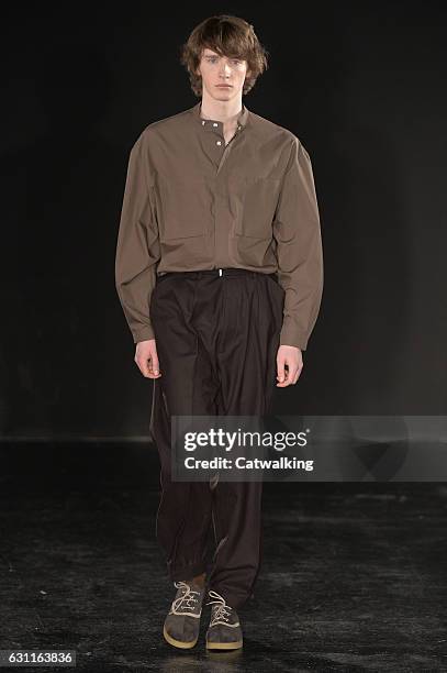 Model walks the runway at the E. Tautz Autumn Winter 2017 fashion show during London Menswear Fashion Week on January 7, 2017 in London, United...