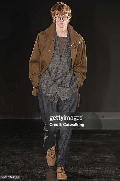 Model walks the runway at the E. Tautz Autumn Winter 2017 fashion show during London Menswear Fashion Week on January 7, 2017 in London, United...