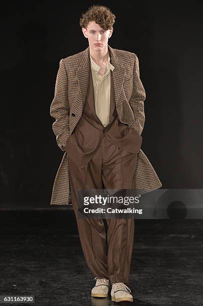 Model walks the runway at the E. Tautz Autumn Winter 2017 fashion show during London Menswear Fashion Week on January 7, 2017 in London, United...