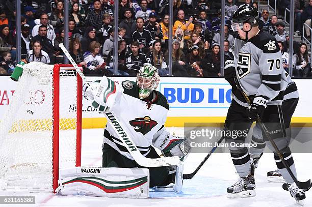 Darcy Kuemper of the Minnesota Wild gets scored on as Tanner Pearson of the Los Angeles Kings battles in front of the net during the game on January...