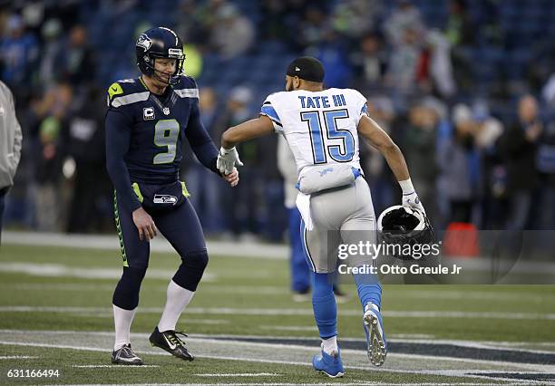 Punter Jon Ryan of the Seattle Seahawks greets wide receiver Golden Tate of the Detroit Lions before the game in the NFC Wild Card game at...