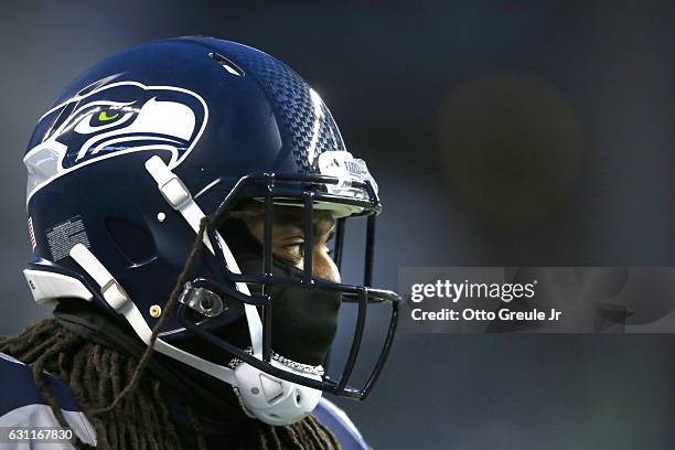 Cornerback Richard Sherman of the Seattle Seahawks seen bundled up during warmup exercises before an NFL game against the Detroit Lions in the NFC...