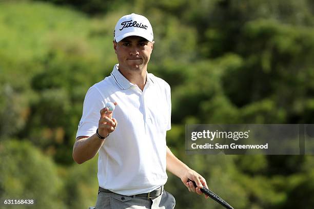 Justin Thomas of the United States reacts after putting on the 17th green during the third round of the SBS Tournament of Champions at the Plantation...