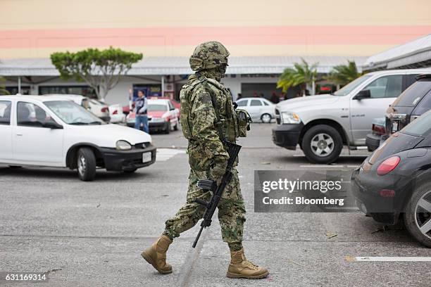 Mexican marine patrols a commercial plaza after looting in Veracruz City, Mexico, on Saturday, Jan. 7, 2017. Mexico's National Association Of Retail...