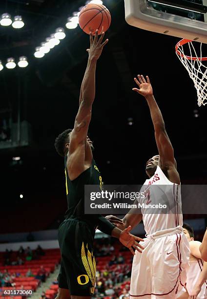 Dylan Ennis of the Oregon Ducks puts up a shot against Ike Iroegbu of the Washington State Cougars in the second half at Beasley Coliseum on January...