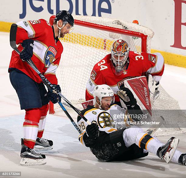 Dominic Moore of the Boston Bruins tangles with Goaltender James Reimer and Jakub Kindl of the Florida Panthers at the BB&T Center on January 7, 2017...