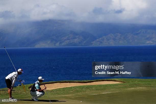 Hideki Matsuyama of Japan lines up a putt on the 12th green during the third round of the SBS Tournament of Champions at the Plantation Course at...