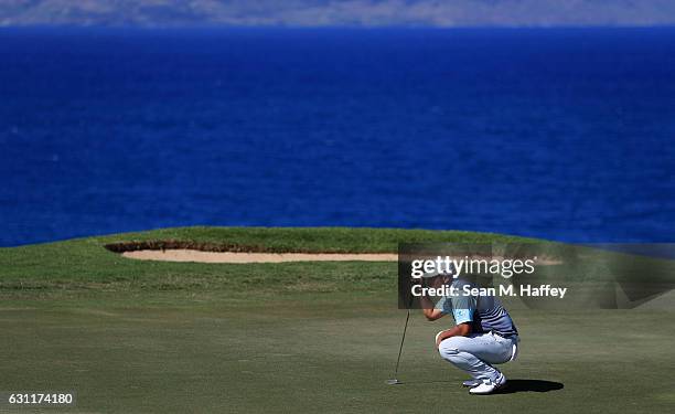 Hideki Matsuyama of Japan lines up a putt on the 12th green during the third round of the SBS Tournament of Champions at the Plantation Course at...