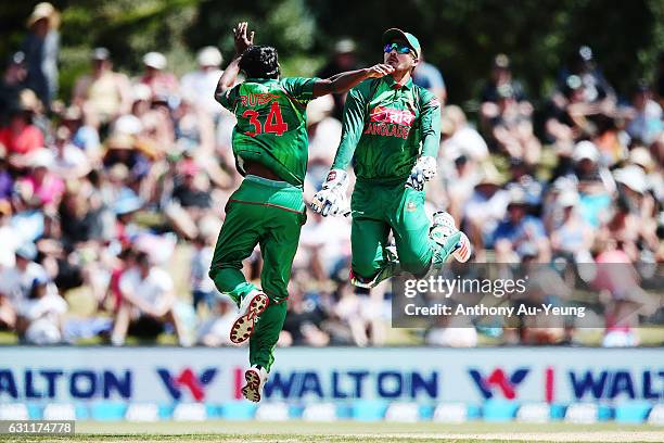 Rubel Hossain of Bangladesh celebrates with teammate Nurul Hasan on a LBW to dismiss James Neesham of New Zealand during the third Twenty20...