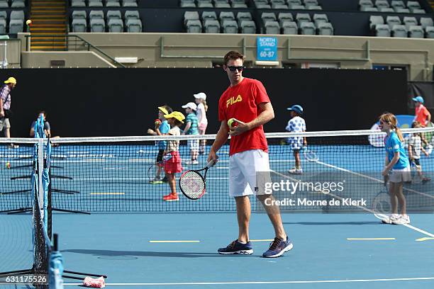 Australian tennis player John Peers plays tennis with kids at Memorial Drive Tennis court during the 2017 World Tennis Challenge Kids Day on January...