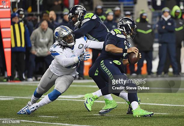 Ezekiel Ansah of the Detroit Lions attempts to tackle Russell Wilson of the Seattle Seahawks during the first half of the NFC Wild Card game at...