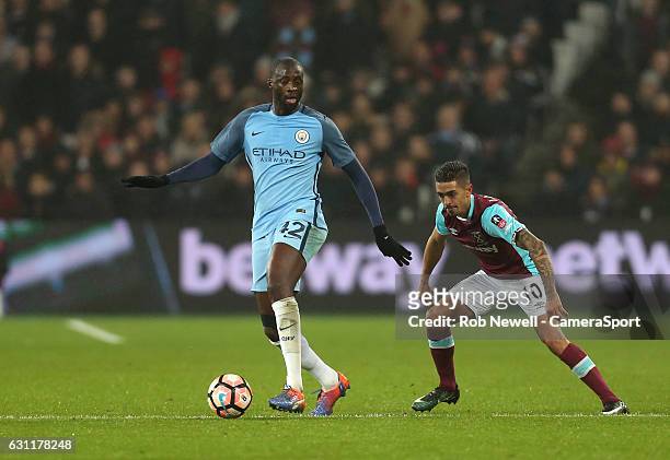 Manchester City's Yaya Toure and West Ham United's Manuel Lanzini during the Emirates FA Cup Third Round match between West Ham United and Manchester...