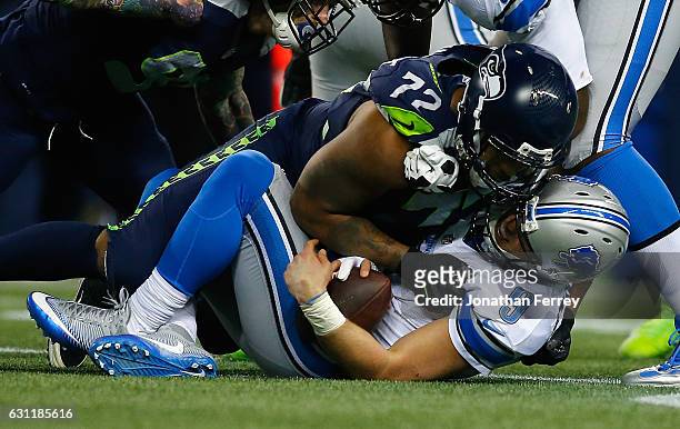 Matthew Stafford of the Detroit Lions is sacked by Michael Bennett of the Seattle Seahawks during the second half of the NFC Wild Card game at...