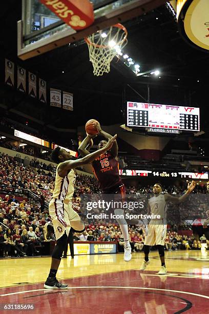 Chris Clarke guard/forward Virginia Tech Hokies attempts a jump shot against Jarquez Smith forward Florida State University Seminoles in an Atlantic...