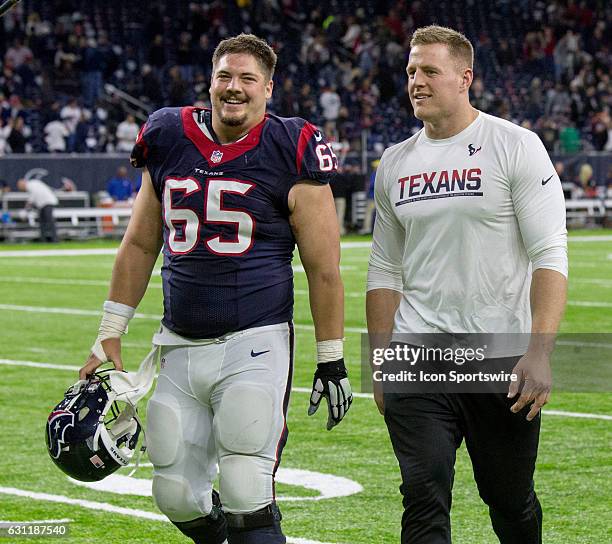 Houston Texans center Greg Mancz and J.J. Watt walks off the field after the AFC Wild Card football game between the Houston Texans and the Oakland...