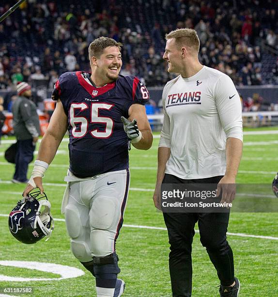Houston Texans center Greg Mancz and J.J. Watt walks off the field after the AFC Wild Card football game between the Houston Texans and the Oakland...