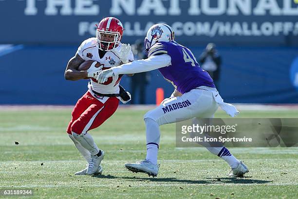 Youngstown State Penguins running back Jody Webb runs towards the sidelines as James Madison Dukes safety Jordan Brown tackles him during the NCAA...