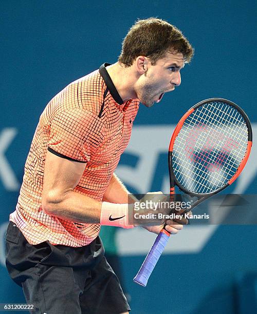 Grigor Dimitrov of Bulgaria celebrates winning the first set against Kei Nishikori of Japan during the Men's Final on day eight of the 2017 Brisbane...