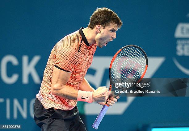 Grigor Dimitrov of Bulgaria celebrates winning the first set against Kei Nishikori of Japan during the Men's Final on day eight of the 2017 Brisbane...