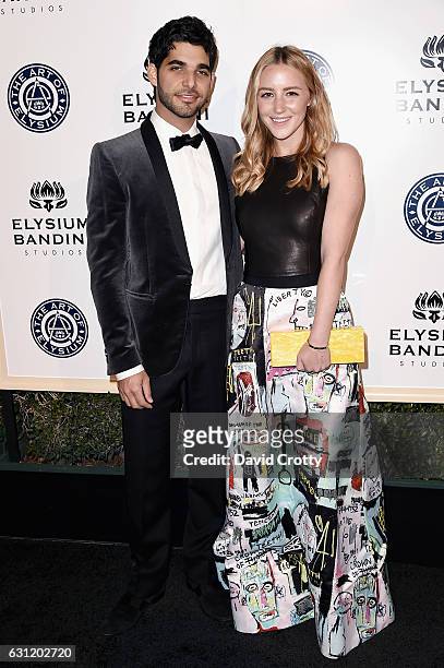 Freddy Wexler and Olivia Zaro attend The Art of Elysium presents Stevie Wonder's HEAVEN - Celebrating the 10th Anniversary - Arrivals at Red Studios...