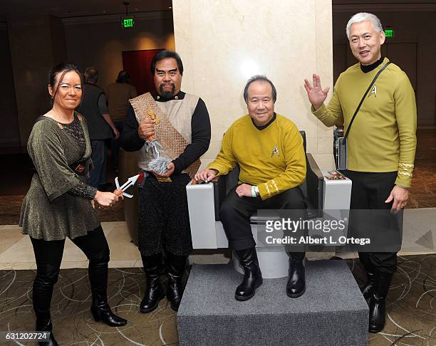 Star Trek cosplayers Michelle Wells, Bill Arucan, David Cheng and Mark Lum pose with the Captain's Chair provided by The Hollywood Sci-Fi Museum at...
