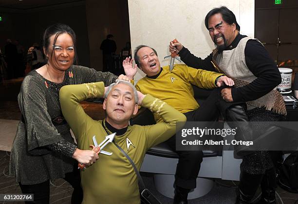 Star Trek cosplayers Michelle Wells, Mark Lum, David Cheng and Bill Arucan pose with the Captain's Chair provided by The Hollywood Sci-Fi Museum at...