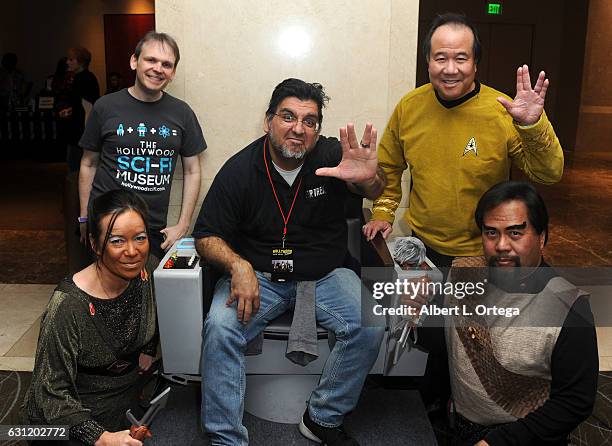 Star Trek cosplayers Michelle Wells, Mark Lum, David Cheng and Bill Arucan pose with the Captain's Chair provided by The Hollywood Sci-Fi Museum at...