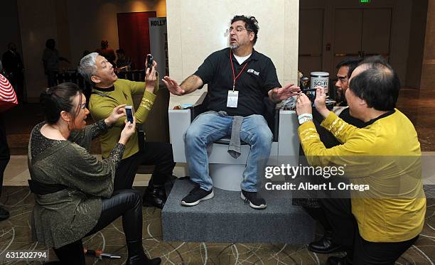 Star Trek cosplayers Michelle Wells, Mark Lum, David Cheng and Bill Arucan pose with the Captain's Chair provided by The Hollywood Sci-Fi Museum at...