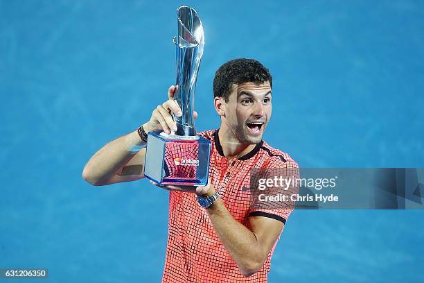 Grigor Dimitrov of Bulgaria holds the Roy Emerson trophy after winning the Men's Final against Kei Nishikori of Japan during day eight of the...