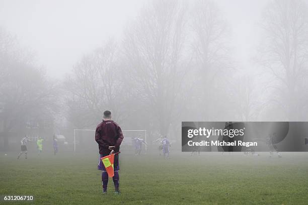 View of a linesman in the fog during a park football match ahead of the Emirates FA Cup Third Round match between Preston North End and Arsenal at...