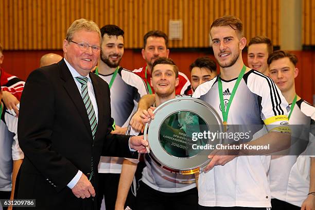 Hermann Korfmacher, president of West-German football federation hands out the winning trophy to Michael Meyer of Hamburg on the podium of the DFB...