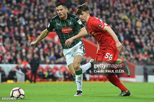 Plymouth's Scottish defender Gary Miller vies with Liverpool's Welsh striker Ben Woodburn during the English FA Cup third round football match...