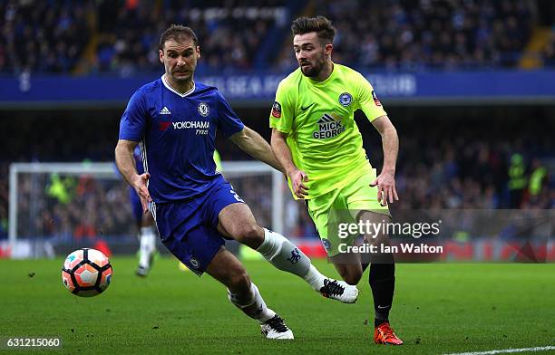 Branislav Ivanovic of Chelsea is put under pressure from Gwion Edwards of Peterborough United during The Emirates FA Cup Third Round match between...